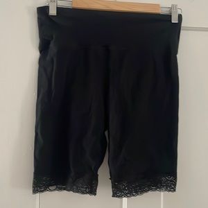 Woman’s size medium black biker shorts with lace detail.